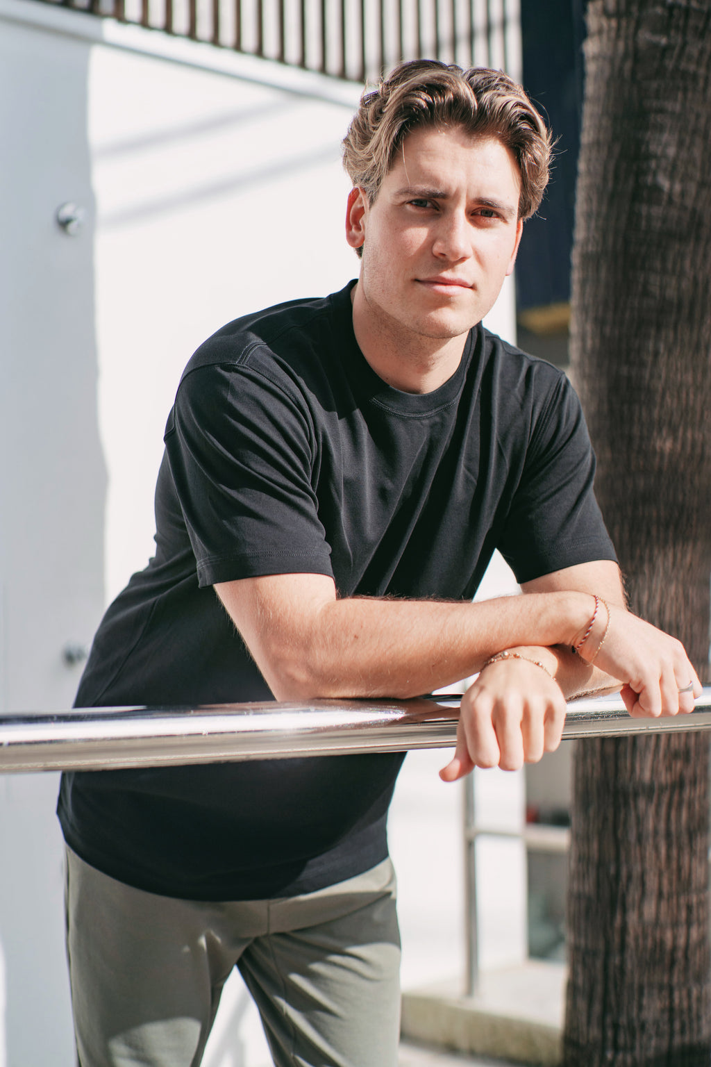 Man wearing black Premium Heavyweight Cotton T-Shirt, close-up showing crew neck and relaxed sleeve fit